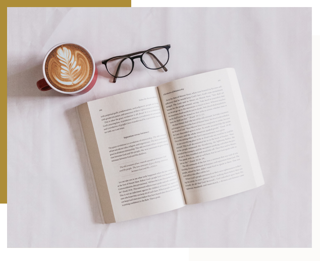 A book with glasses and coffee on it